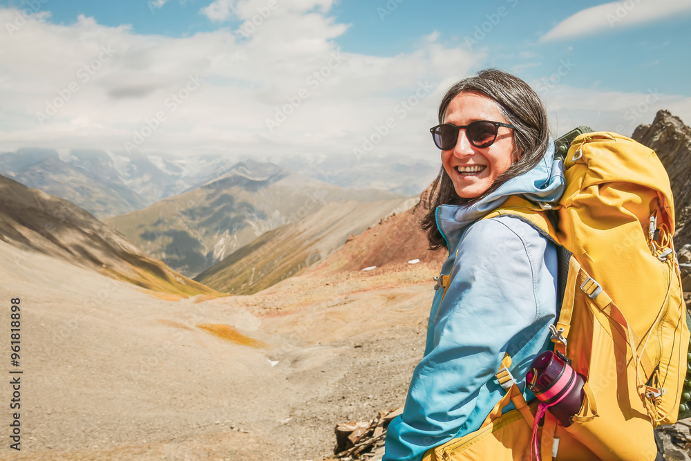 Close up Young woman guide portrait hiking mountains - Happy hiker on the top of the cliff smiling at camera - Travel and hobby concept Close up Young woman guide portrait hiking mountains - Happy hiker on the top of the cliff smiling at camera - Travel and hobby concept
