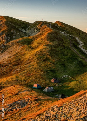 Sunrise from the ridge of the Western Tatras, Rohace with a view of the Salatin mountain with grass illuminated by the rising sun, camping and bivouac in nature. Tatras, tourist theme, tourist trail. photo