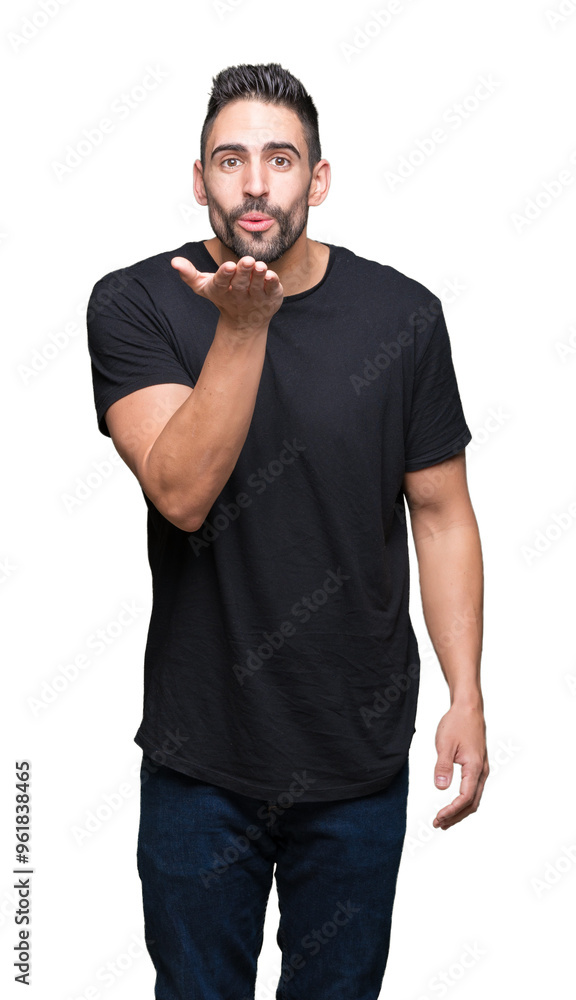 Young handsome man over isolated background looking at the camera blowing a kiss with hand on air being lovely and sexy. Love expression. Young handsome man over isolated background looking at the camera blowing a kiss with hand on air being lovely and sexy. Love expression.