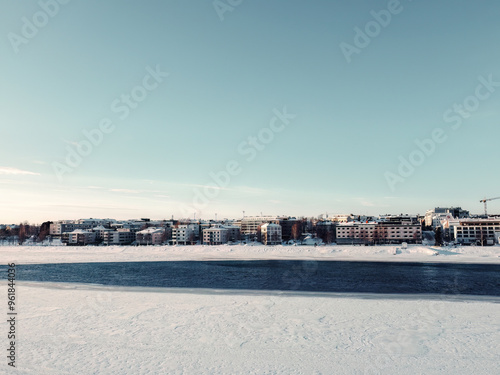 Half frozen Ounasjoki river in front of Rovaniemi aerial shot in Lapland photo