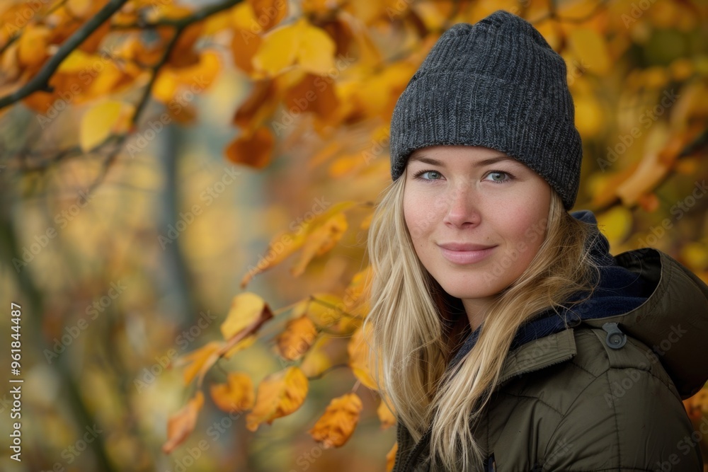 A woman wearing a grey hat and a green jacket is smiling A woman wearing a grey hat and a green jacket is smiling