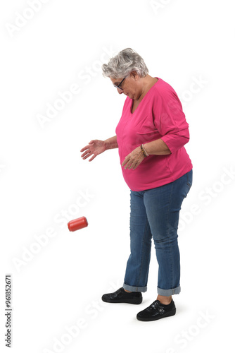 older woman throwing a can on the ground on white background photo