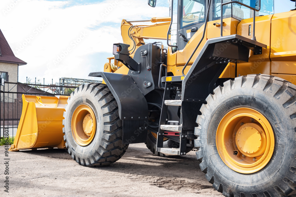Yellow tractor at the back. Construction equipment. Yellow tractor at the back. Construction equipment.