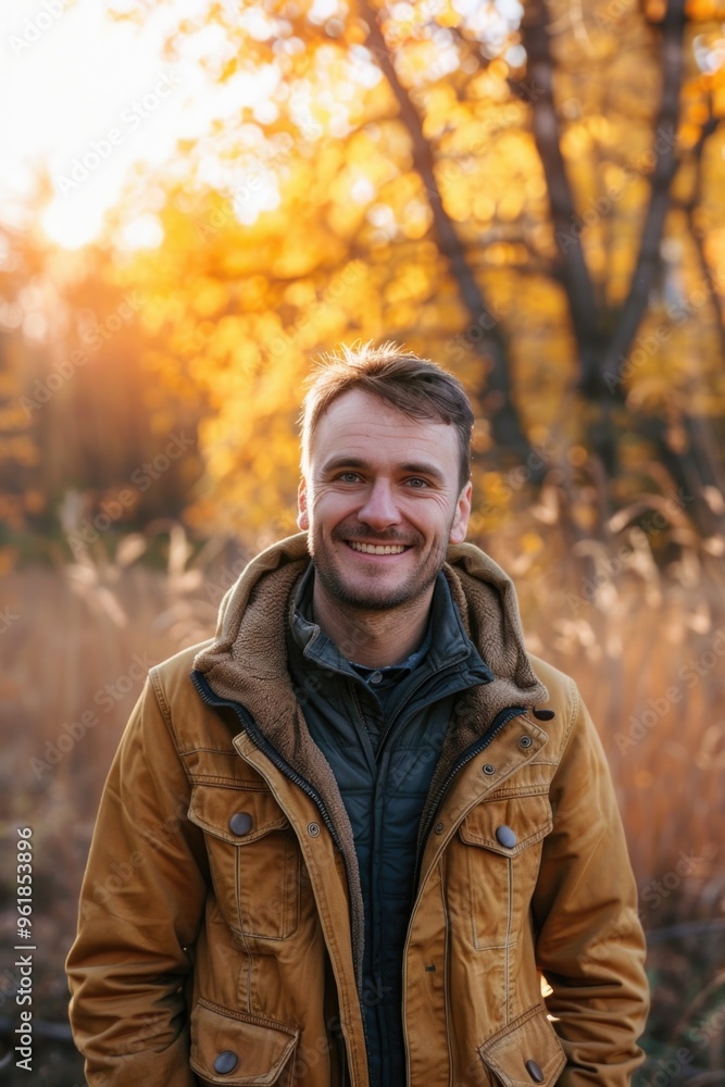 A man in a yellow jacket is smiling and looking at the camera A man in a yellow jacket is smiling and looking at the camera