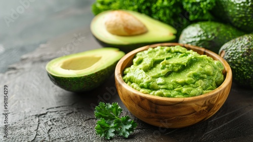 appetizing guacamole in a wooden bowl on a rustic table