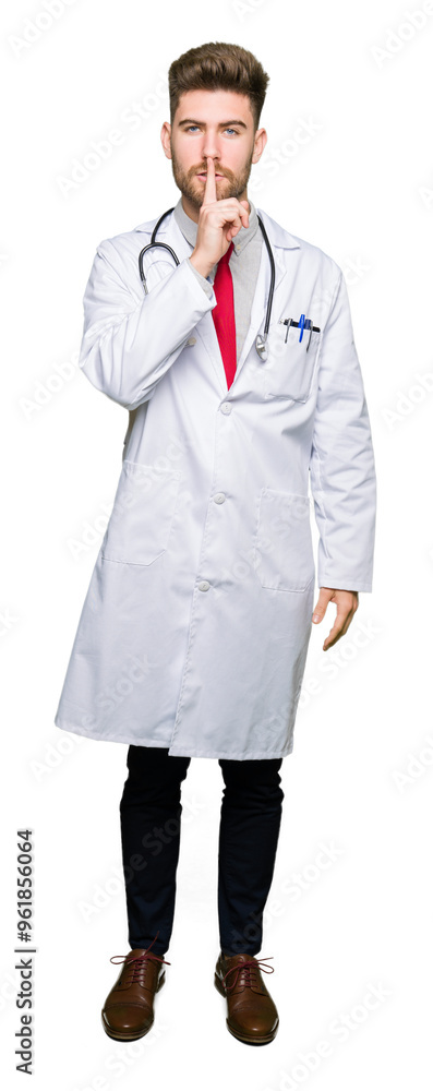 Young handsome doctor man wearing medical coat asking to be quiet with finger on lips. Silence and secret concept. Young handsome doctor man wearing medical coat asking to be quiet with finger on lips. Silence and secret concept.