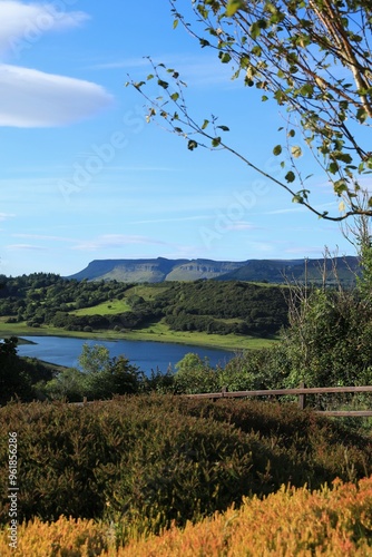 Landscape in rural County Sligo, Ireland in Autumn featuring Benbulben Mountain and nearby hills viewed from garden shrubbery across Lough Colgagh 