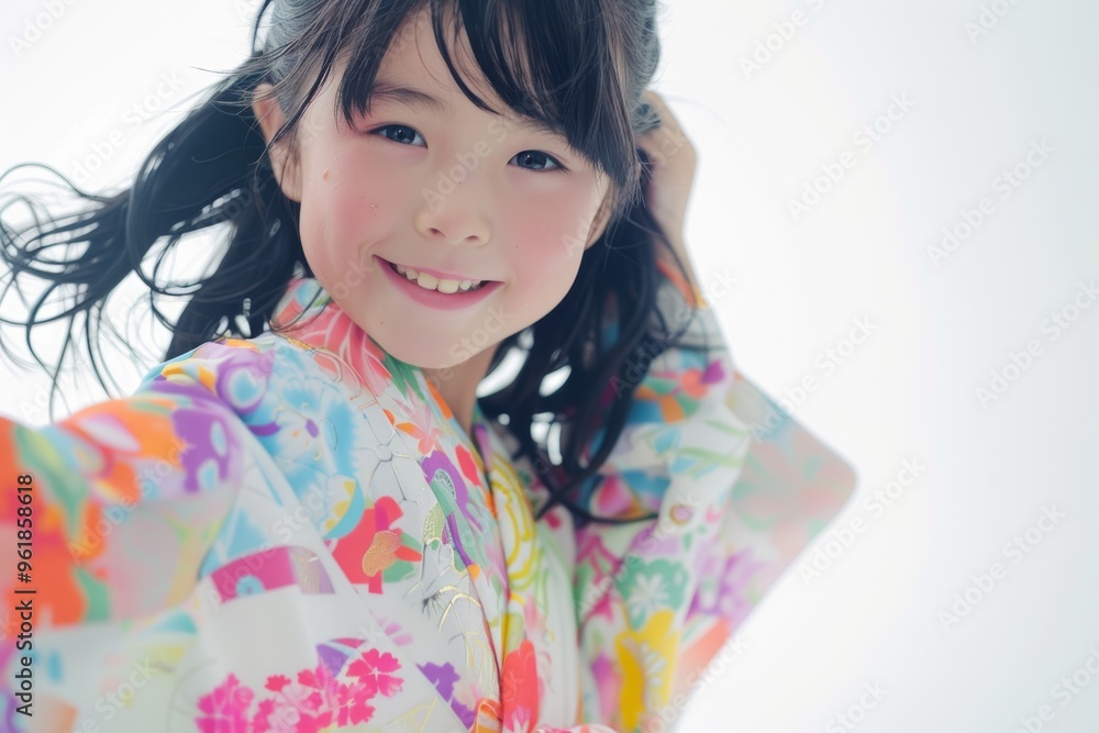 A cute Japanese girl wearing a high-contrast colorful kimono and a random hairstyle poses against a white background. A cute Japanese girl wearing a high-contrast colorful kimono and a random hairstyle poses against a white background.