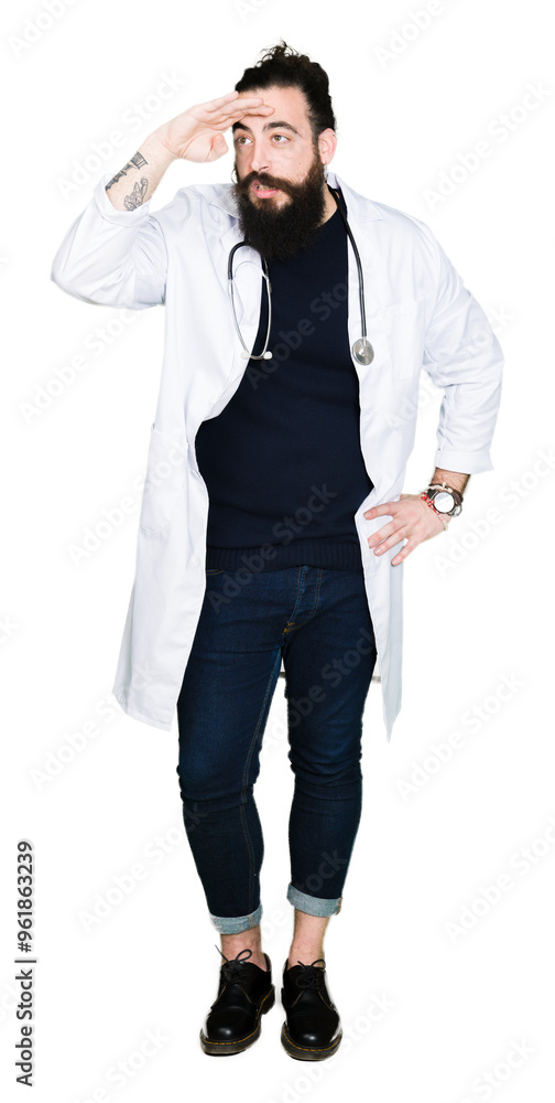 Doctor with long hair wearing medical coat and stethoscope very happy and smiling looking far away with hand over head. Searching concept. Doctor with long hair wearing medical coat and stethoscope very happy and smiling looking far away with hand over head. Searching concept.