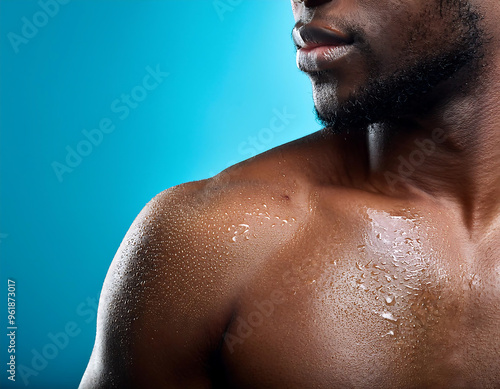  Wet skin with water droplets on a shoulder, close-up on a blue background, symbolizing hydr_1(896) photo