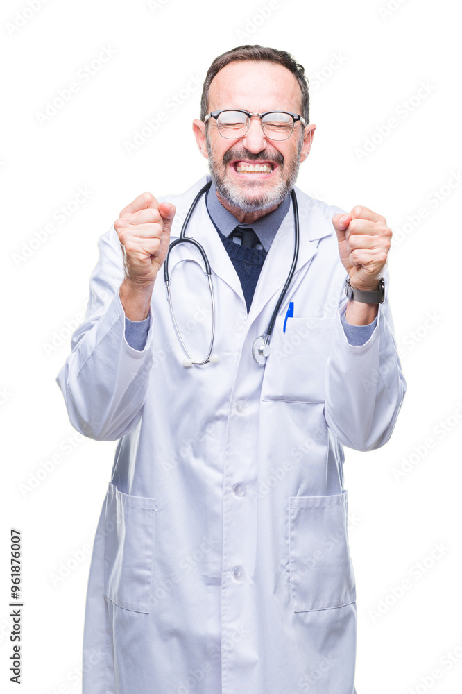 Middle age senior hoary doctor man wearing medical uniform isolated background excited for success with arms raised celebrating victory smiling. Winner concept. Middle age senior hoary doctor man wearing medical uniform isolated background excited for success with arms raised celebrating victory smiling. Winner concept.