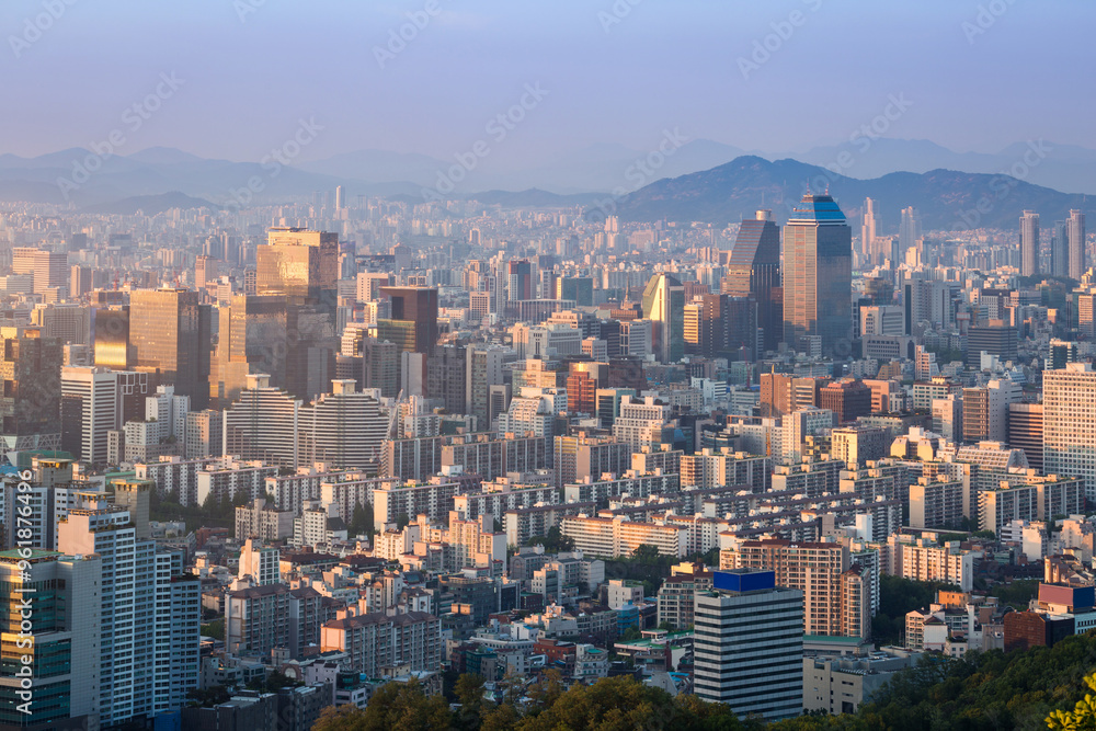 Fototapeta premium Seoul city and skyscrapers in Gangnam district in the afternoon, with light fog and Bukhansan Mountain in the background, Seoul, South Korea.