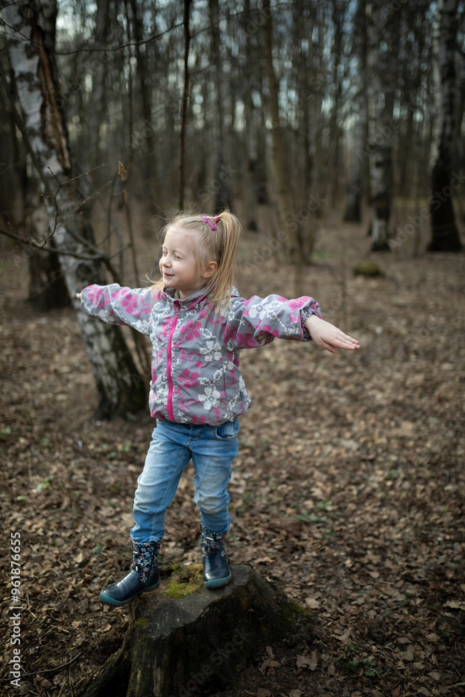 Portrait of cute little girl playing in the forest at the daytime of late autumn Portrait of cute little girl playing in the forest at the daytime of late autumn