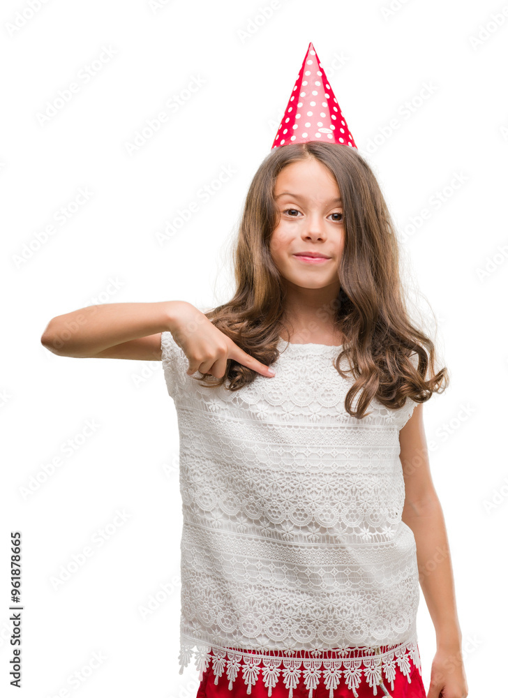 Brunette hispanic girl wearing birthday hat with surprise face pointing finger to himself Brunette hispanic girl wearing birthday hat with surprise face pointing finger to himself