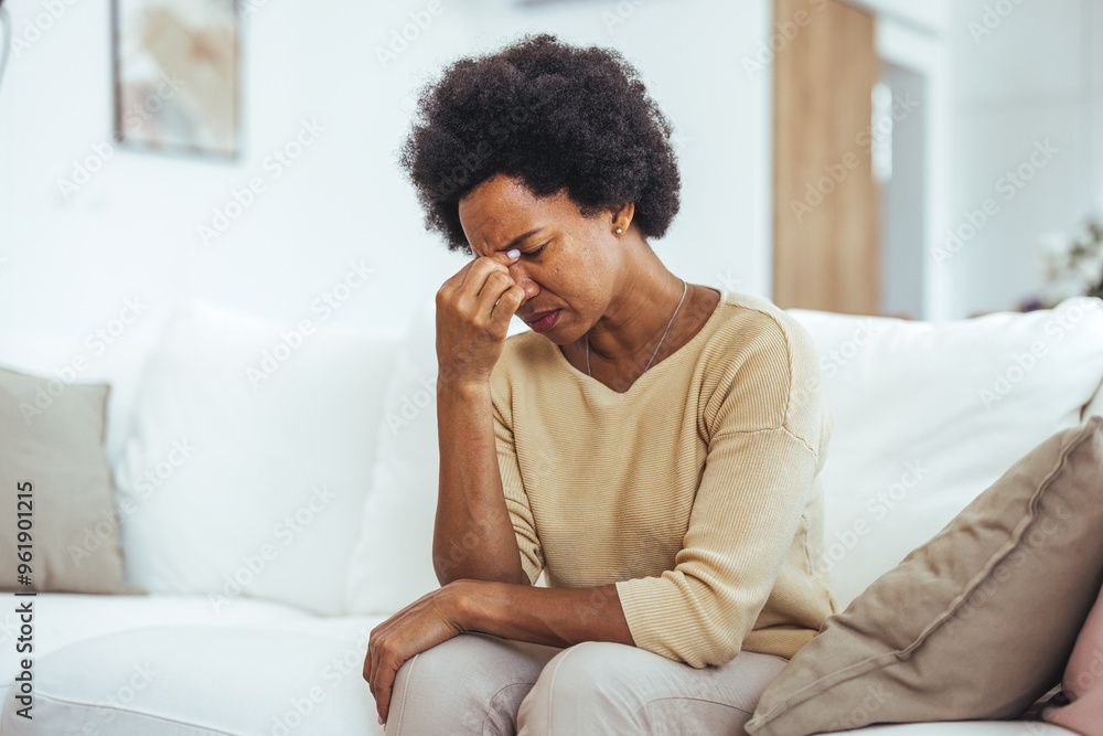 Stressed Woman Sitting on Sofa Feeling Overwhelmed at Home Stressed Woman Sitting on Sofa Feeling Overwhelmed at Home
