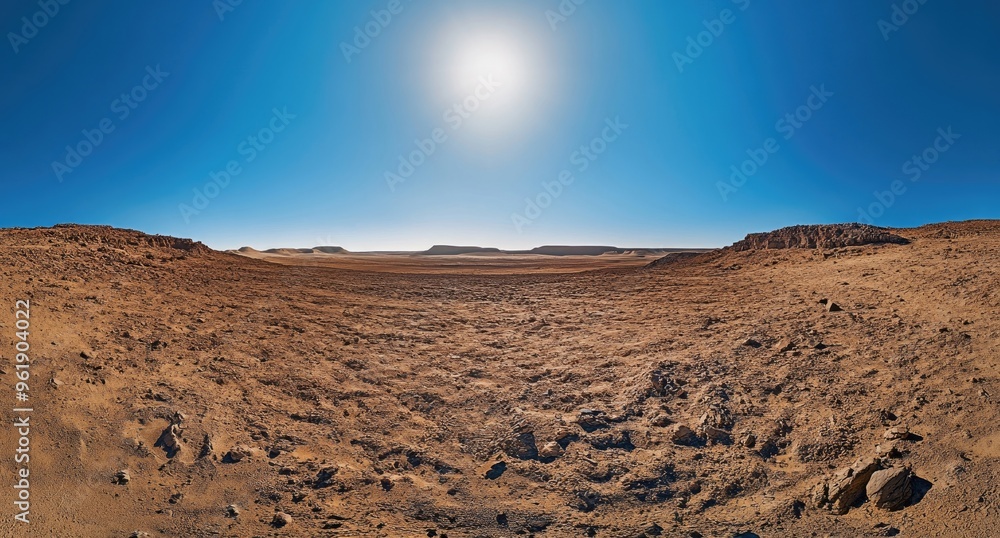 Naklejka premium Sunlit Desert Landscape: Arid Terrain and Clear Sky