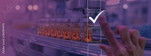 a hand touching a digital checkmark interface, symbolizing quality control or approval. The background shows vials on a production line in a pharmaceutical or medical setting photo