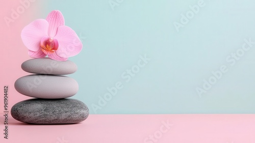 A serene composition of stacked stones with a delicate pink orchid against a pastel background, symbolizing tranquility and balance.