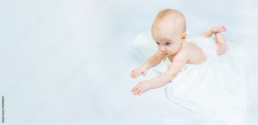 a baby with a hemangioma on his neck lies on a white background. banner with a copy space. profile of a little bald baby girl. the kid looks to the side
