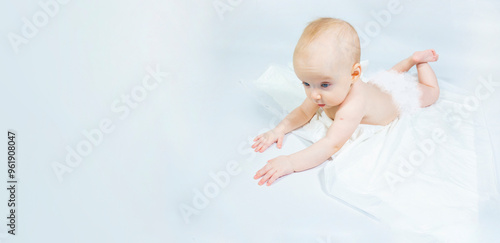 Obraz na płótnie a baby with a hemangioma on his neck lies on a white background. banner with a copy space. profile of a little bald baby girl. the kid looks to the side w salonie