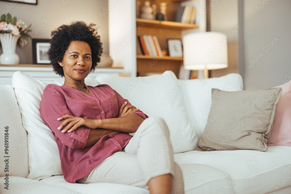 Confident Woman Relaxing on Cozy White Sofa at Home Confident Woman Relaxing on Cozy White Sofa at Home
