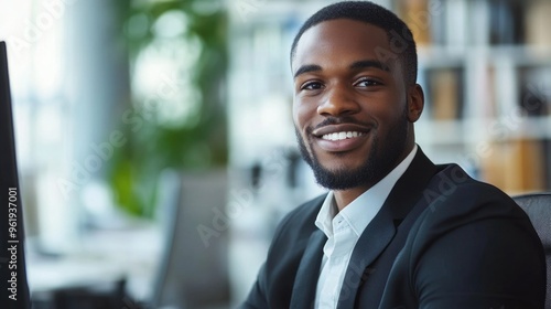 A man in a suit and tie is smiling at the camera