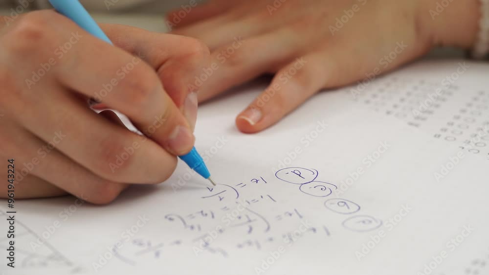 High school teenagers in classroom, close up shot girl writing math exam, solving task on paper sheet. Modern education concept. High school teenagers in classroom, close up shot girl writing math exam, solving task on paper sheet. Modern education concept.