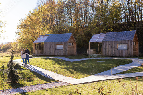 Loving couple relaxing walking through glamping center, enjoying nature and escape from everyday life. Tourism and travel concept. photo