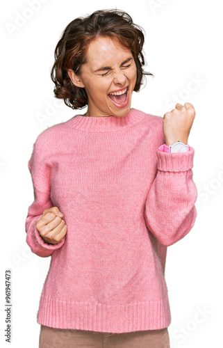 Young hispanic woman wearing casual clothes celebrating surprised and amazed for success with arms raised and eyes closed. winner concept.