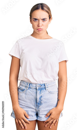 Young beautiful blonde woman wearing casual white tshirt depressed and worry for distress, crying angry and afraid. sad expression.