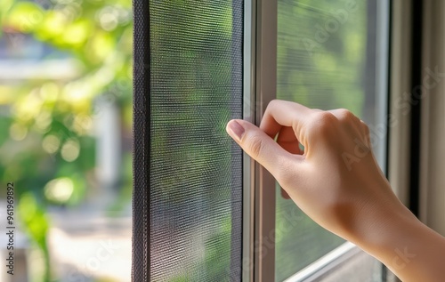 Woman operates retractable insect screen to open or close window for mosquito protection Free Download Woman operates retractable insect screen to open or close window for mosquito protection - GFXLoad