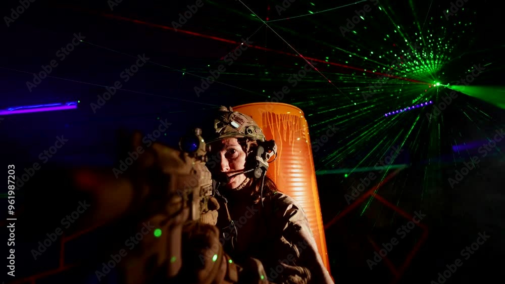A woman in a military uniform with a submachine gun, illuminated by green and purple lasers, prepares for action in a dark room. The atmosphere is dynamic and intense. A woman in a military uniform with a submachine gun, illuminated by green and purple lasers, prepares for action in a dark room. The atmosphere is dynamic and intense.