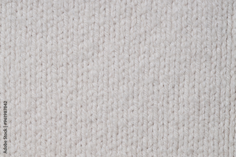 Texture of white knitted fabric with pattern as background, top view Texture of white knitted fabric with pattern as background, top view