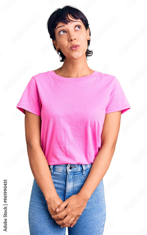 Young brunette woman with short hair wearing casual clothes smiling looking to the side and staring away thinking. Young brunette woman with short hair wearing casual clothes smiling looking to the side and staring away thinking.