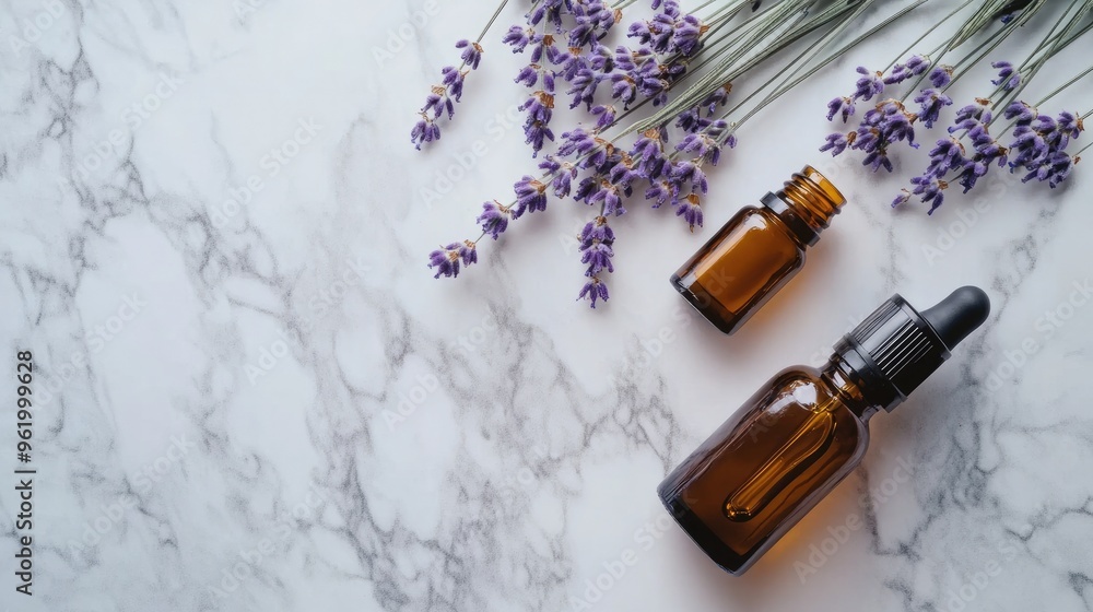 Lavender essential oil bottles arranged with sprigs of lavender, set on a marble surface with minimalist decor Lavender essential oil bottles arranged with sprigs of lavender, set on a marble surface with minimalist decor