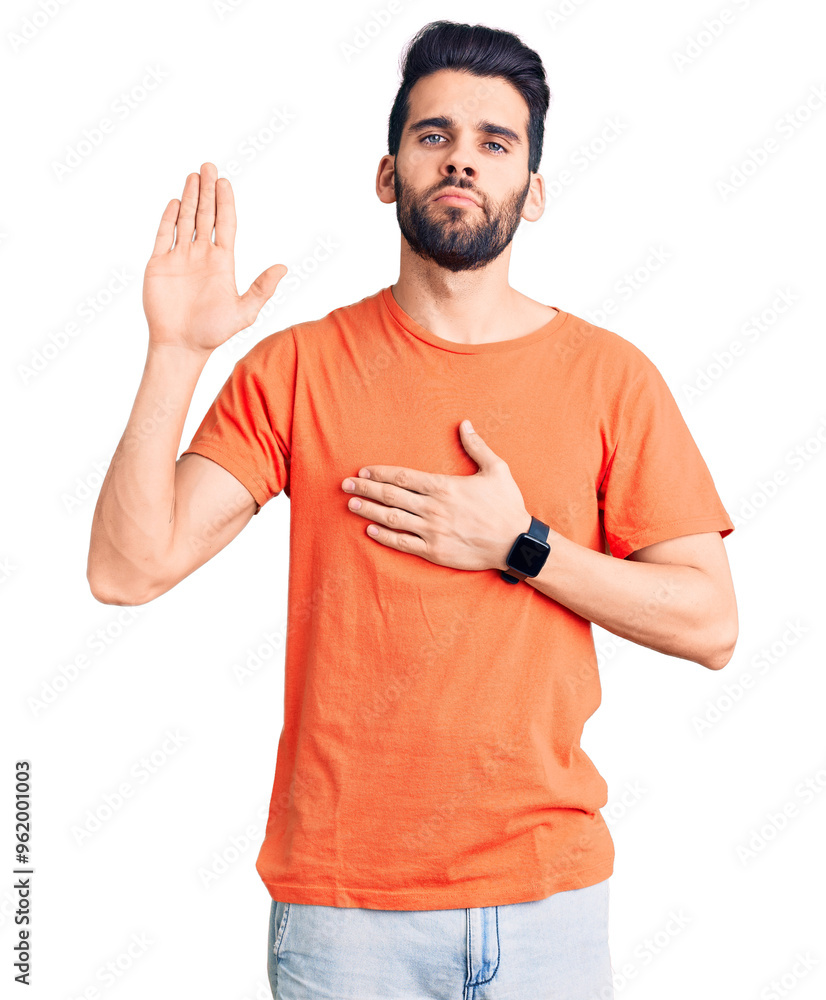 Young handsome man with beard wearing casual t-shirt swearing with hand on chest and open palm, making a loyalty promise oath Young handsome man with beard wearing casual t-shirt swearing with hand on chest and open palm, making a loyalty promise oath