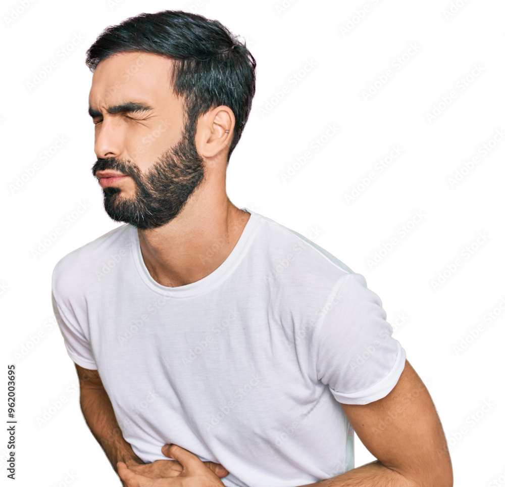 Obraz premium Young hispanic man wearing casual white t shirt with hand on stomach because nausea, painful disease feeling unwell. ache concept.