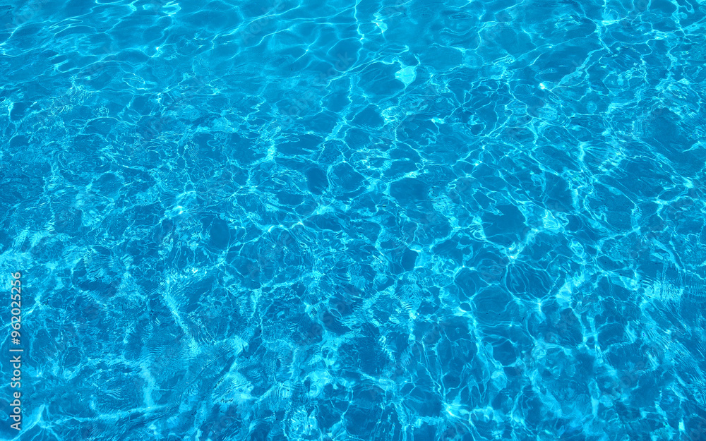 Crystal clear water texture with sun reflections, showcasing vibrant blue ripples and waves. Ideal for background designs, water-themed projects, or nature visuals. Crystal clear water texture with sun reflections, showcasing vibrant blue ripples and waves. Ideal for background designs, water-themed projects, or nature visuals.