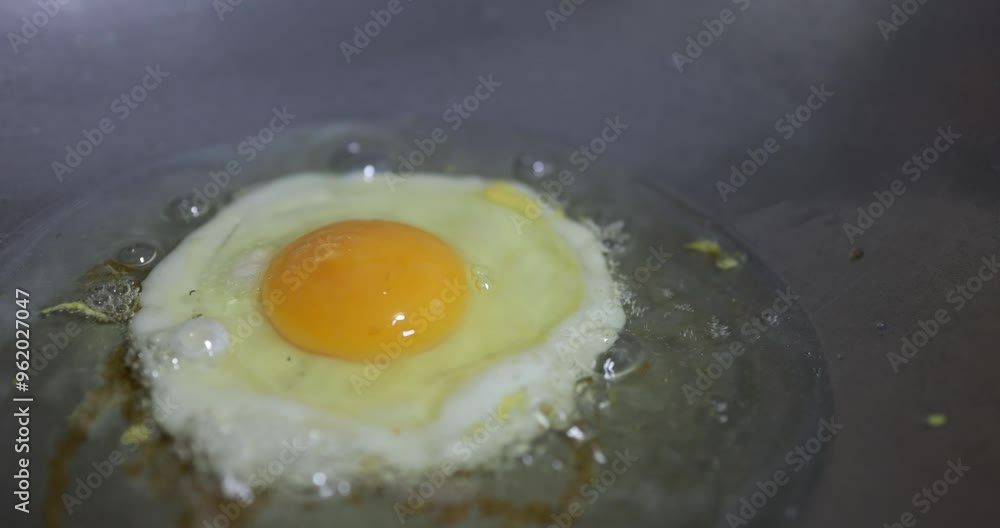 Fry fried eggs in boiling oil in a hot pan over a gas stove. Fry fried eggs in boiling oil in a hot pan over a gas stove.