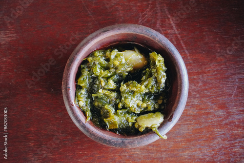 Sambal Ijo or Indonesian spicy green chili sauce made with onion, green chilies, garlic, and salt. photo