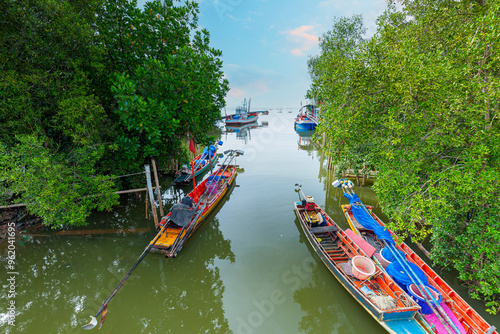 A fishing village with fishing boats moored in Thailand,small fishing boats in asia,Thai fishing boats docked at Samui beach, Thailand in a summy day  photo