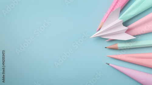 A blue background with a white paper airplane and a row of colorful pencils