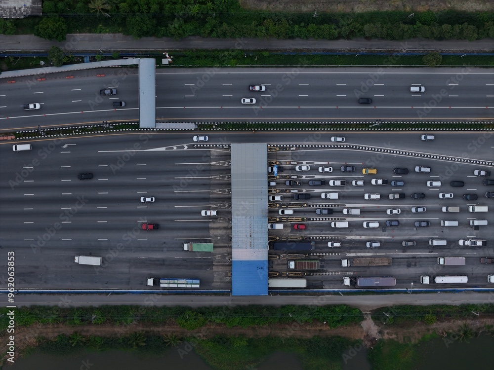 Aerial view of Highway an important infrastructure, expressway road . smart modern motorway , Toll way, road traffic. Aerial view of a busy toll road with many cars queuing up to pay the highway toll Aerial view of Highway an important infrastructure, expressway road . smart modern motorway , Toll way, road traffic. Aerial view of a busy toll road with many cars queuing up to pay the highway toll