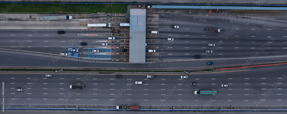 Aerial view of Highway an important infrastructure, expressway road . smart modern motorway , Toll way, road traffic. Aerial view of a busy toll road with many cars queuing up to pay the highway toll Aerial view of Highway an important infrastructure, expressway road . smart modern motorway , Toll way, road traffic. Aerial view of a busy toll road with many cars queuing up to pay the highway toll