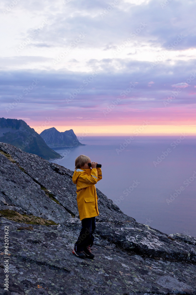 Family with children and pet, hiking Sukkertoppen trail on Senja island, Norway Family with children and pet, hiking Sukkertoppen trail on Senja island, Norway