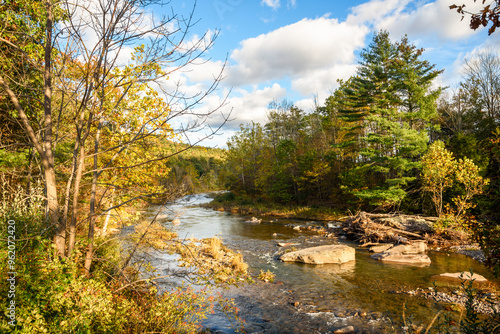 River winding its way through a forested landscape in the mountains at sunset in autumn