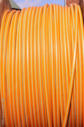 High-speed internet infrastructure deployment featuring a large orange spool of fiber optic cable photo