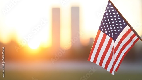 American Flag Fluttering in Morning Light - Silhouette of Twin Towers Creating a Poignant Moment of Remembrance and Patriotism