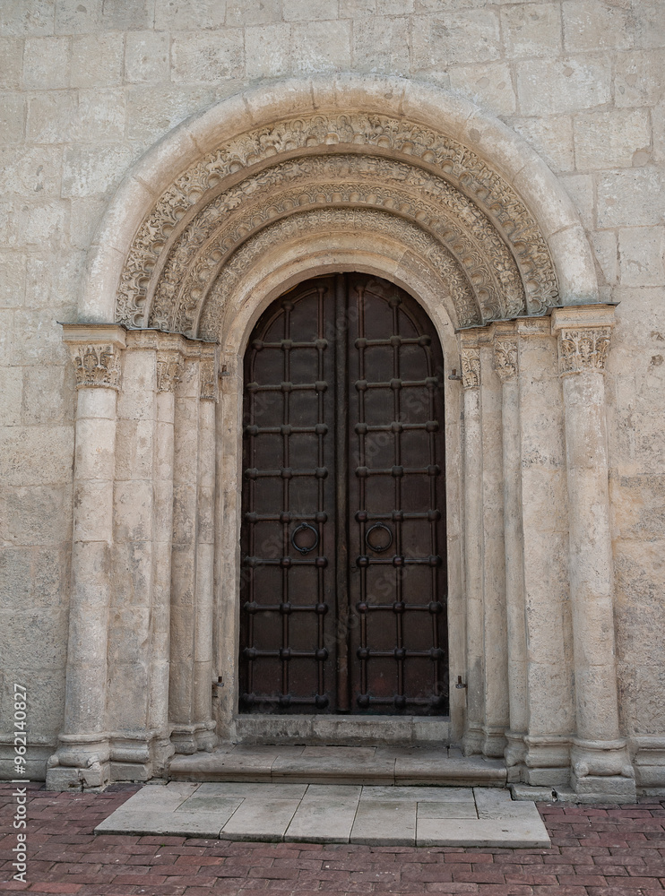Ornate door on an ancient church with historical architecture Ornate door on an ancient church with historical architecture
