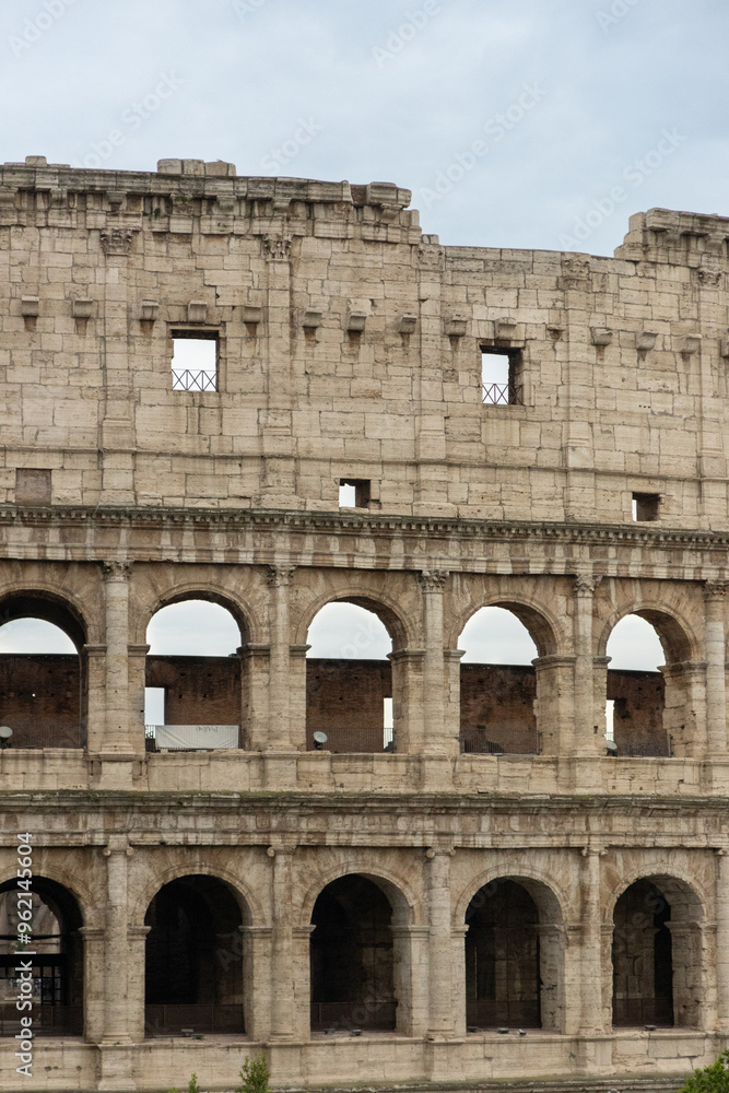 Obraz premium Roman Colosseum, the largest ancient amphitheatre ever built, Italy. Arches, exterior facade. Giardinetto del Monte Oppio. Rome, Italy